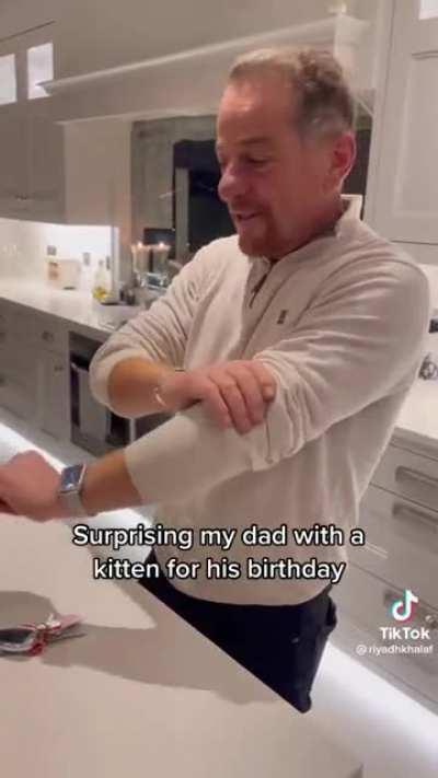 Surprising their dad with the kitten he's always wanted.
