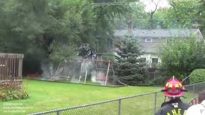 Power line landed on a metal swing set
