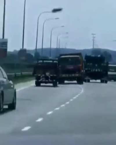 Truck tows another truck with a chain