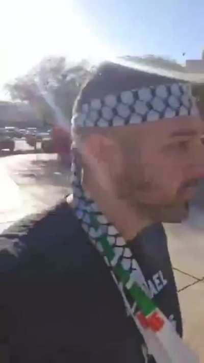 Crazy Zionist assaults Palestinian protester, cops come and detain the Palestinian. 