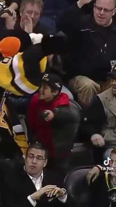 Old man steals puck from a kid.
