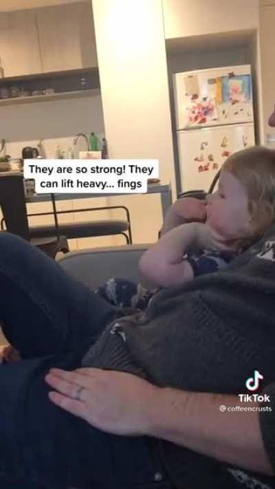 A girl watches women lifting weights