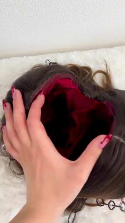 Woman makes a 3D Printed head purse.