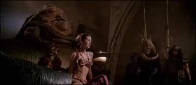 Slave Leia Closes Her Eyes As Jabba Pulls Her Chain Causing Her Body Tighten And Her Stomach To Flex
