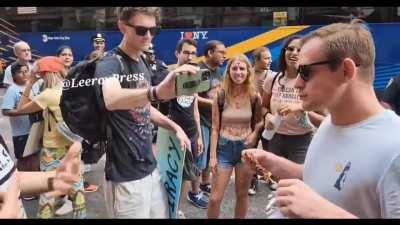 NYC Man enjoying a tasty burger in front of animal rights activists