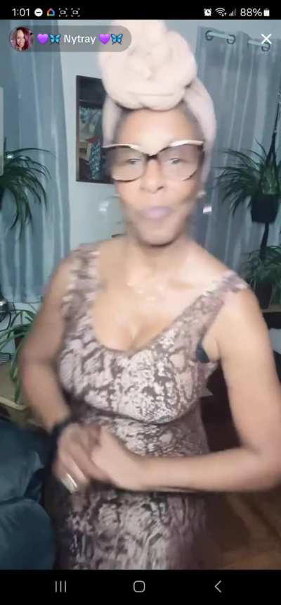 Nytray dancing to savage by Megan thee stallion in hip hugging brown dress 