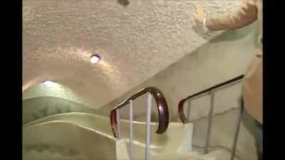 Asian reporter going down slide