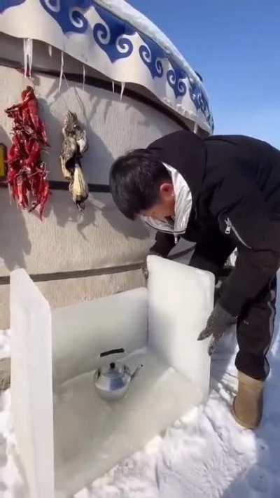 Indigenous man make an outdoor freezer made out of ice
