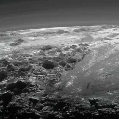 Pluto’s ice mountains, frozen plains, and layers of atmospheric haze as seen by the New Horizons spacecraft.
