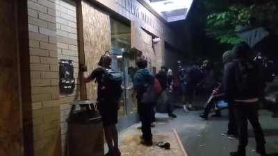 Prior to smashing the windows, the crowd chants 