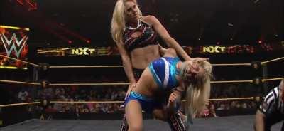 Charlotte exposing Alexa’s stomach with an abdominal stretch