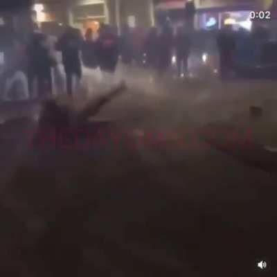 Standing in front of a car doing donuts