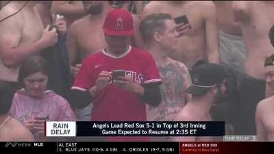 [Highlight] [highlight] A lone Angel fan is standing in the middle of a bunch of shirtless fans in the outfield bleachers at Fenway