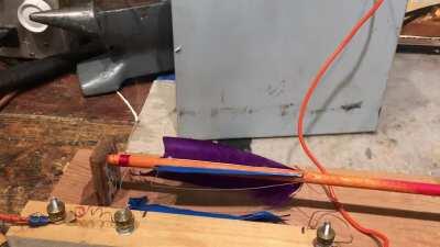 Feather burning an arrow. Finishing up an arrow with a home made feather burner I built.