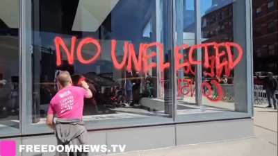 Climate activists tagging windows of a Tesla showroom in downtown Manhattan today