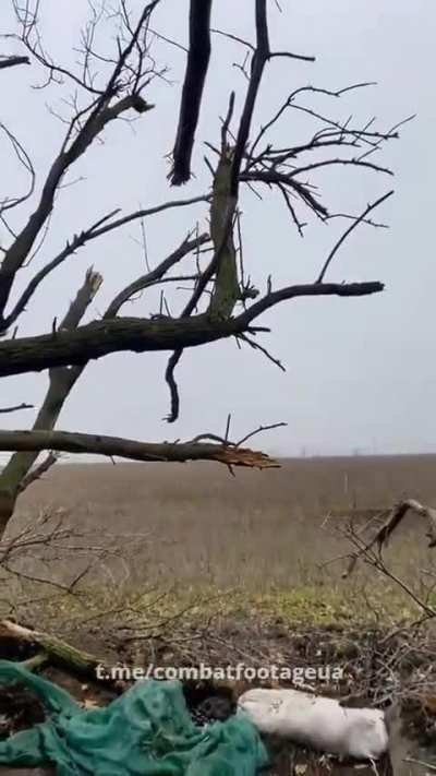 A Ukrainian soldier sitting in a tree fires an FGM-148 Javelin at Russian armoured vehicles. Spring 2023.
