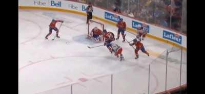 Slafkovsky makes makes a pass with his stick behind his back. 