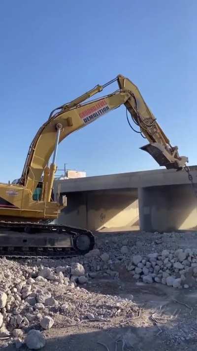 10,000 Pound Wrecking Ball Attached to Excavator