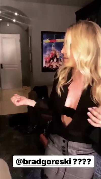 Kaley Cuoco undoing her top