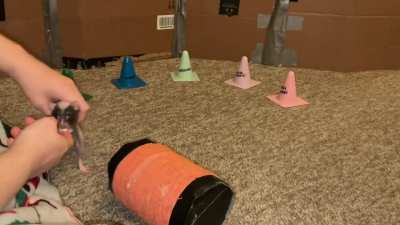 Raisin combining weaving with walking backwards on a rolling barrel!