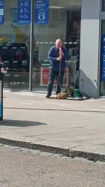 A man singing with a pink 'microphone' in front of Tesco express today. Shall I say more?