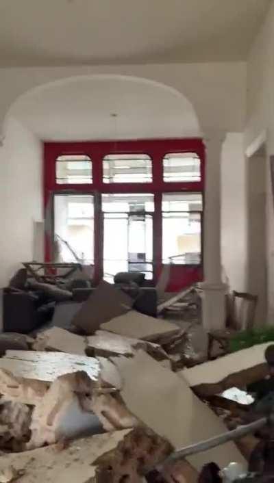 Woman returning to her destroyed apartment in Beirut.