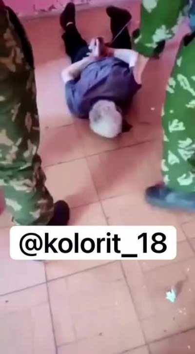 Azerbaijan soldier cuts off ear of a captured Armenian.