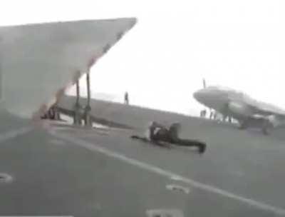 Standing behind a jet engine.