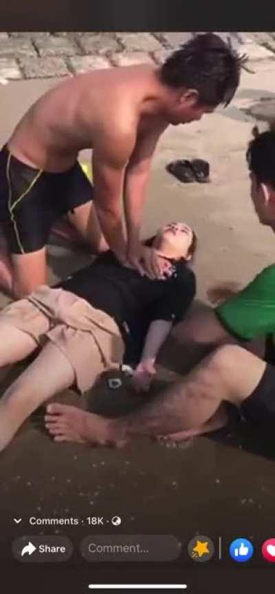 Vietnamese paramedic saving drowned victims.