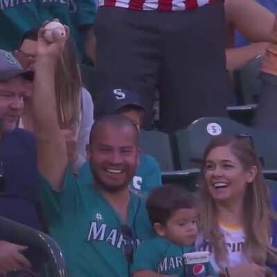 Baby has his drink, dad has the ball.