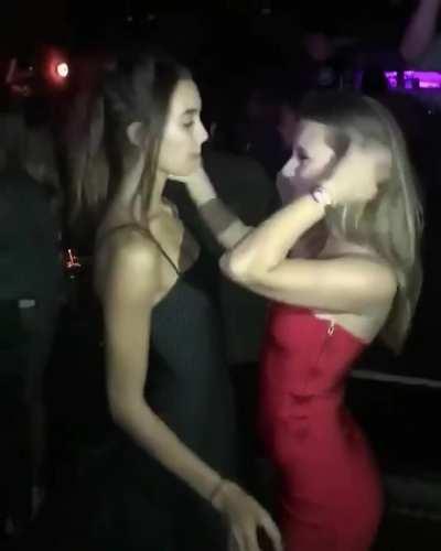Friends kissing at a party