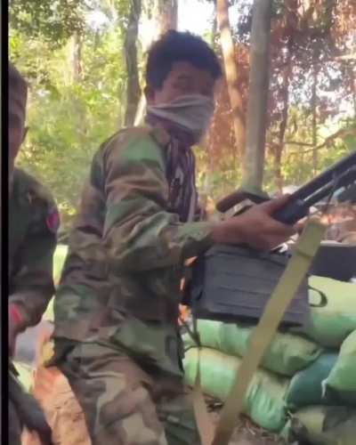 Royal Cambodian Army soldiers firing from their trenches during Thai-Cambodia border clashes.