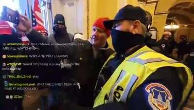 Police ofricer takes a selfie with a Trump supporter inside the US Capitol