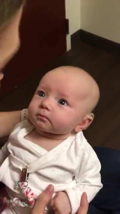 Baby hears mothers voice for the first time with the help of a hearing aid. the reaction is beautiful.