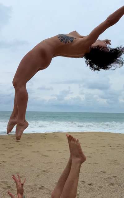 Playtime at the nude beach having fun getting upside-down!