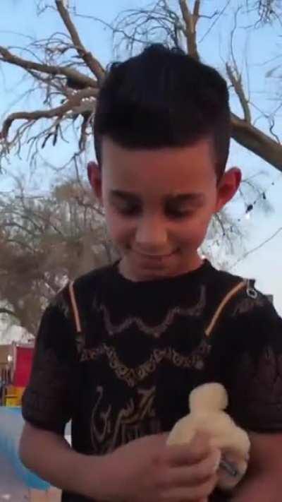 Cute Iraqi kid selling coffee offers free coffee to an American tourist.