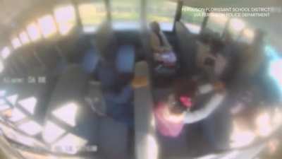A Dad goes onto a school bus, and forces his daughter to beat up another 7 year old girl that was bullying her. (Bad quality video)