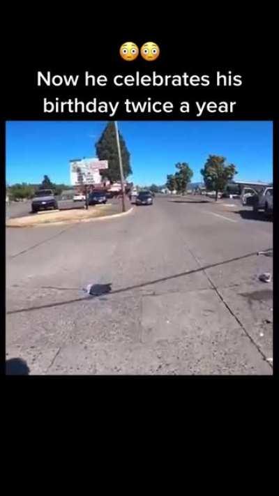 Lucky biker slides under truck to avoid idiot stopped in the road