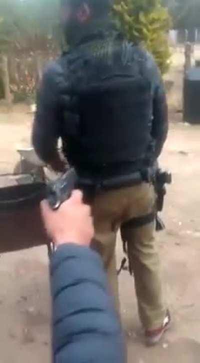 Sicarios test out plate carrier with Beretta M9 en un rancho in Sinaloa, México.