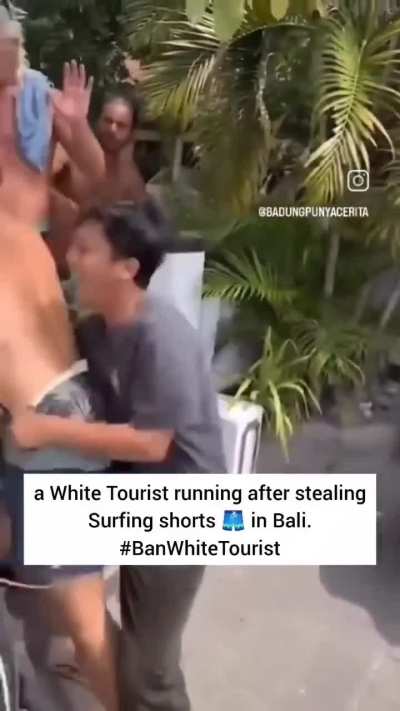 A White tourist running after stealing surfing shorts in Bali