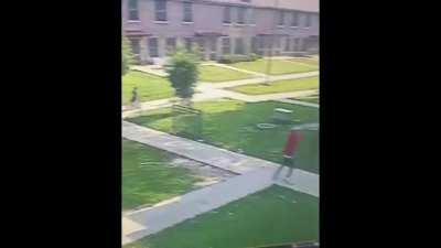 Guy in Chicago pulls up and starts shooting as little kids ride their bikes nearby