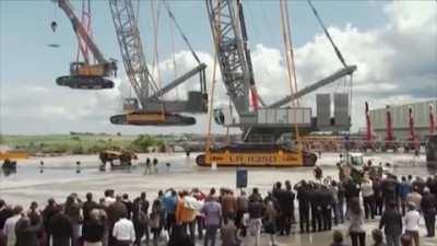 Four Liebherr Cranes (and a model) Lifting Each Other Up