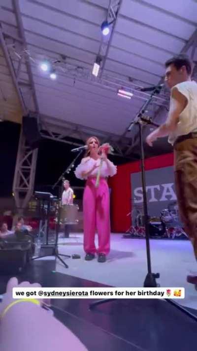 Receiving flowers on stage for her birthday at College Station (Shared by @taramhuynh on April 2023)