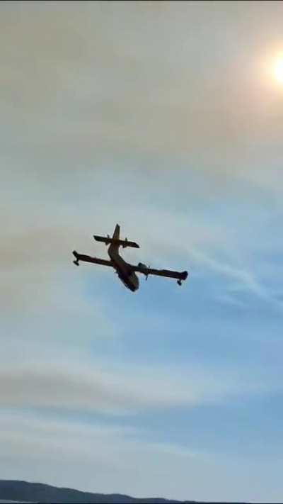 Canadair CL415 flying over me to get water to put out forest fire near Zadar, Croatia. Date: July 30