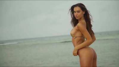 Striking a pose in a gold bikini