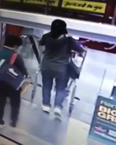 Pushing a stroller down an escalator.