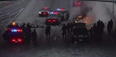 Cocktail molotov thrown at police car during unrest in Los Angeles.