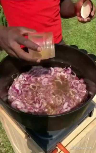 Dennis Ombachi, a Kenyan rugby player and self taught chef, prepares chapati and chicken meals for neighborhood kids.