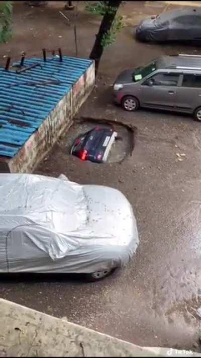 Car falls down hole