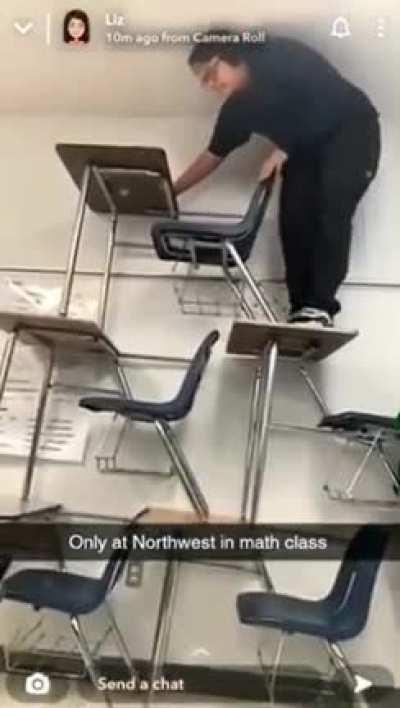 Student trying to be the king of the desks